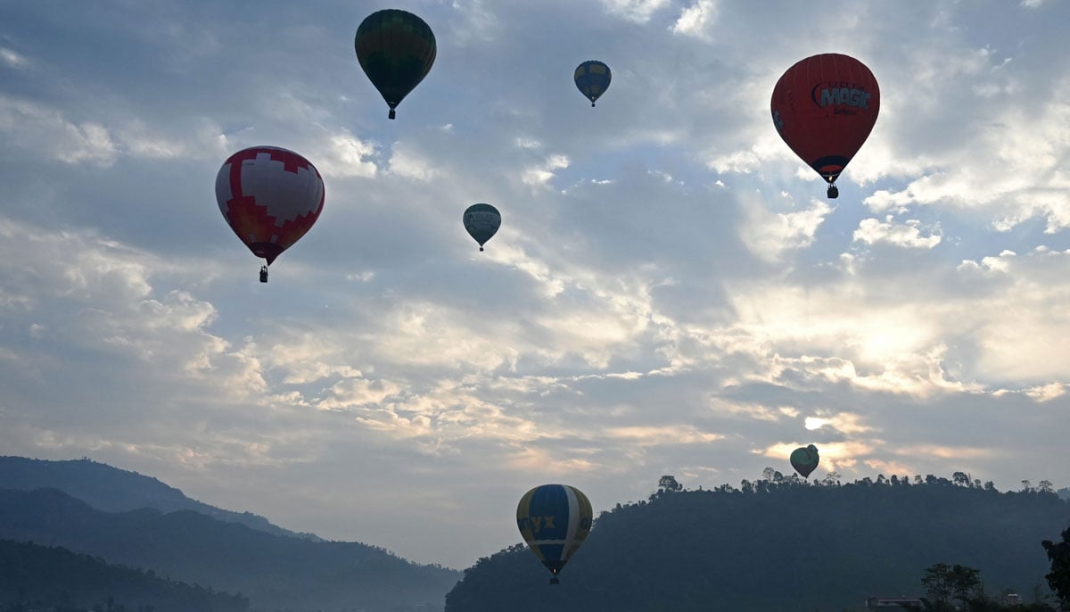 Hot air balloons rise in sky during the international festival at Pokhara in Nepal on December 25, 2024. — AFP