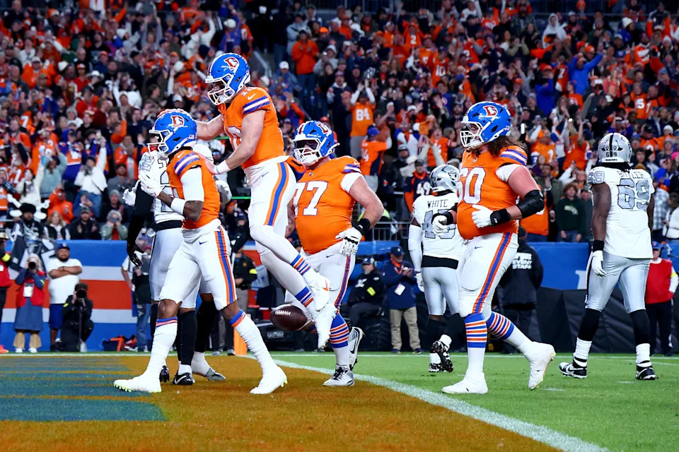 Bo Nix celebrates with Troy Franklin after scoring their only touchdown. (Tyler Schank/Getty Images)